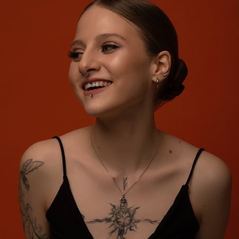 Piercing jewellery laid out on a dark surface