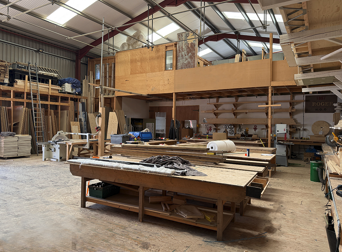 Multi-level carpentry and construction space with workbenches