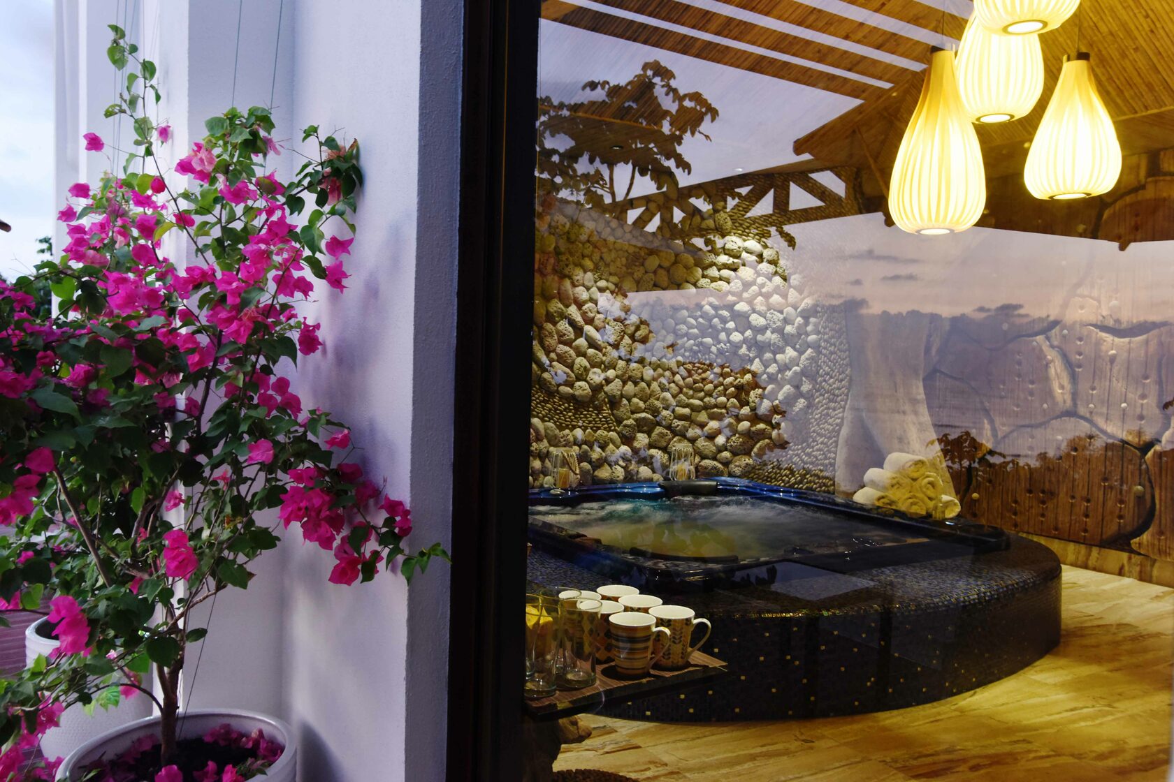 The stone hot tub dressed with tropical flowers