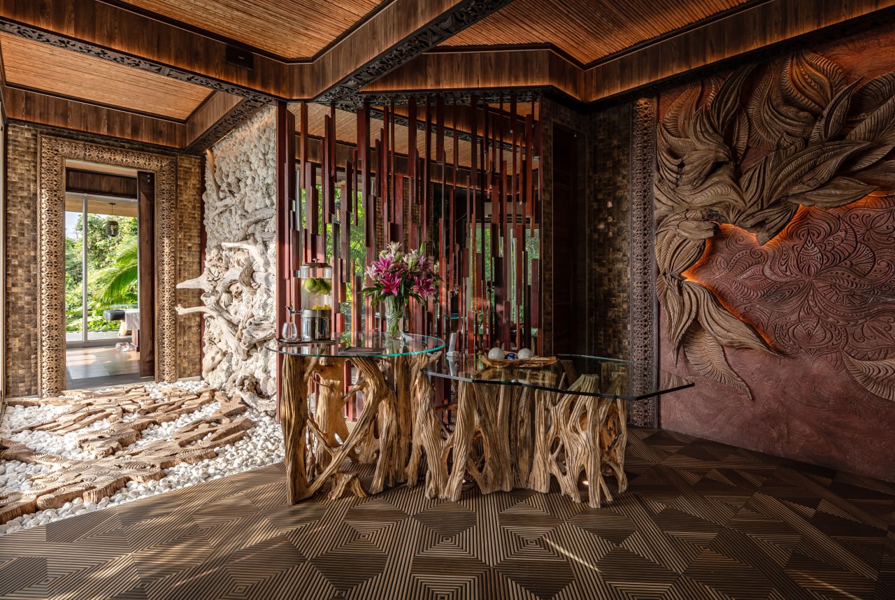 The Shanti Spa hall — carved wood panel and root-wood tables under warm light