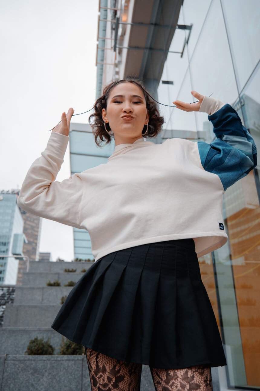 Female model in a white hoodie urban setting