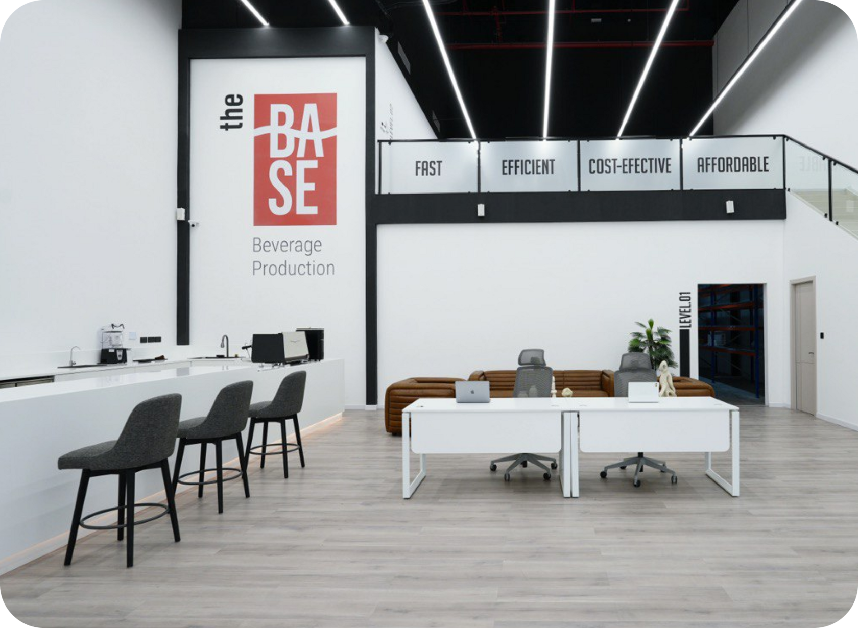 Modern showroom and R&amp;D facility of The Base Beverage with branding and signage highlighting speed, efficiency, and quality