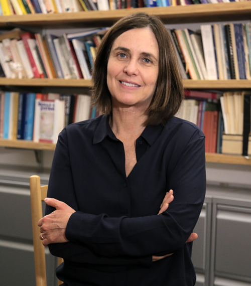 Shafi Goldwasser, Israeli-American computer scientist, standing in front of a bookshelf in an academic office. Known for her pioneering work in cryptography and computer science.