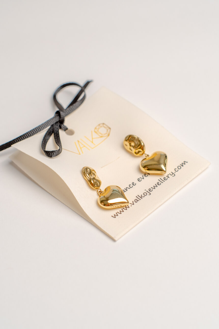 Product photography of gold heart earrings