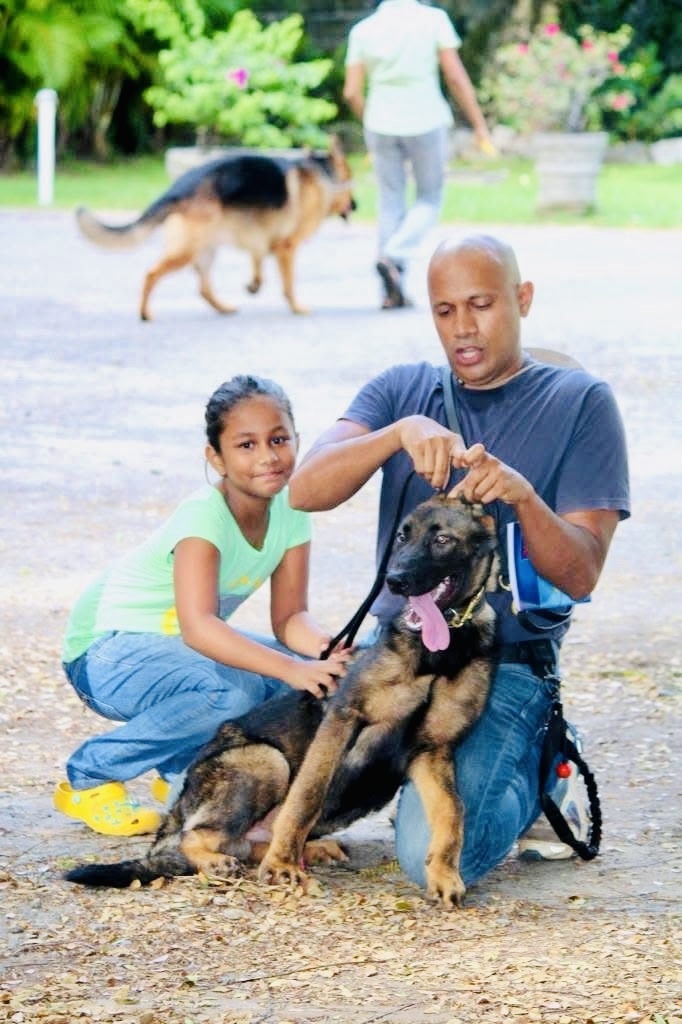 VONFIDEL K9 trainer guiding a young handler beside a German Shepherd during a training engagement