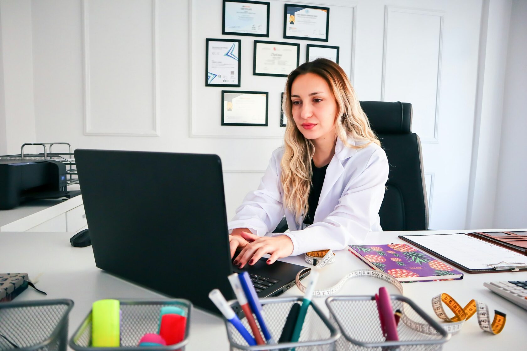Clinic owner working on laptop in a modern med spa