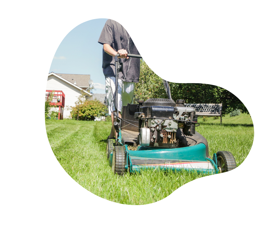Young male mowing a large lawn with a house and red balcony in the background.