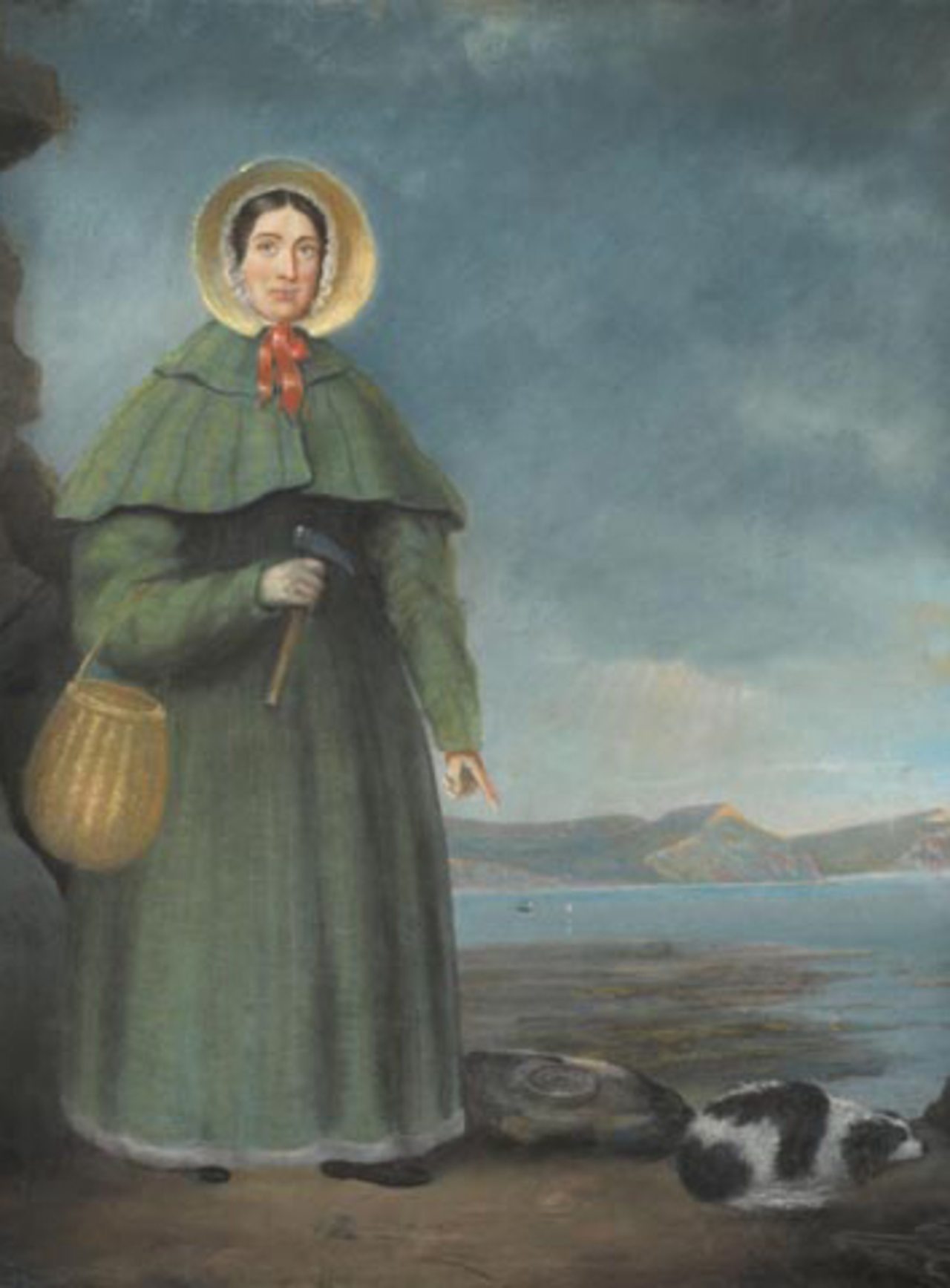 A painting of Mary Anning standing on a rocky shore, wearing a green bonnet and cloak with a red ribbon. She holds a fossil hammer in one hand and a basket hangs from her arm. Beside her is a small black-and-white dog lying near a fossil. The sea and cliffs are visible in the background.