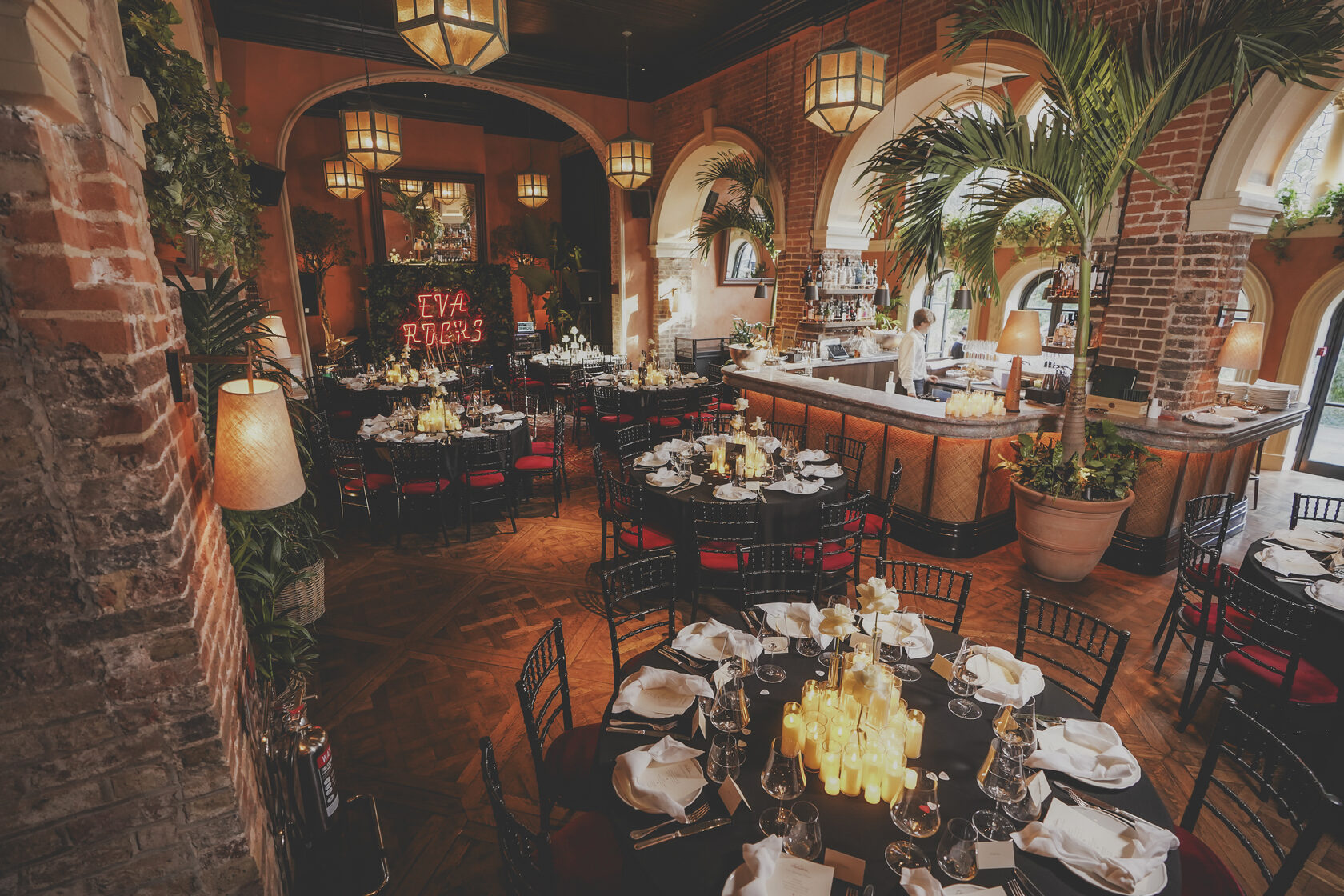 Argentinian tango dancer performs in front of a mantel with flower arrangements in Annabel's members club, London