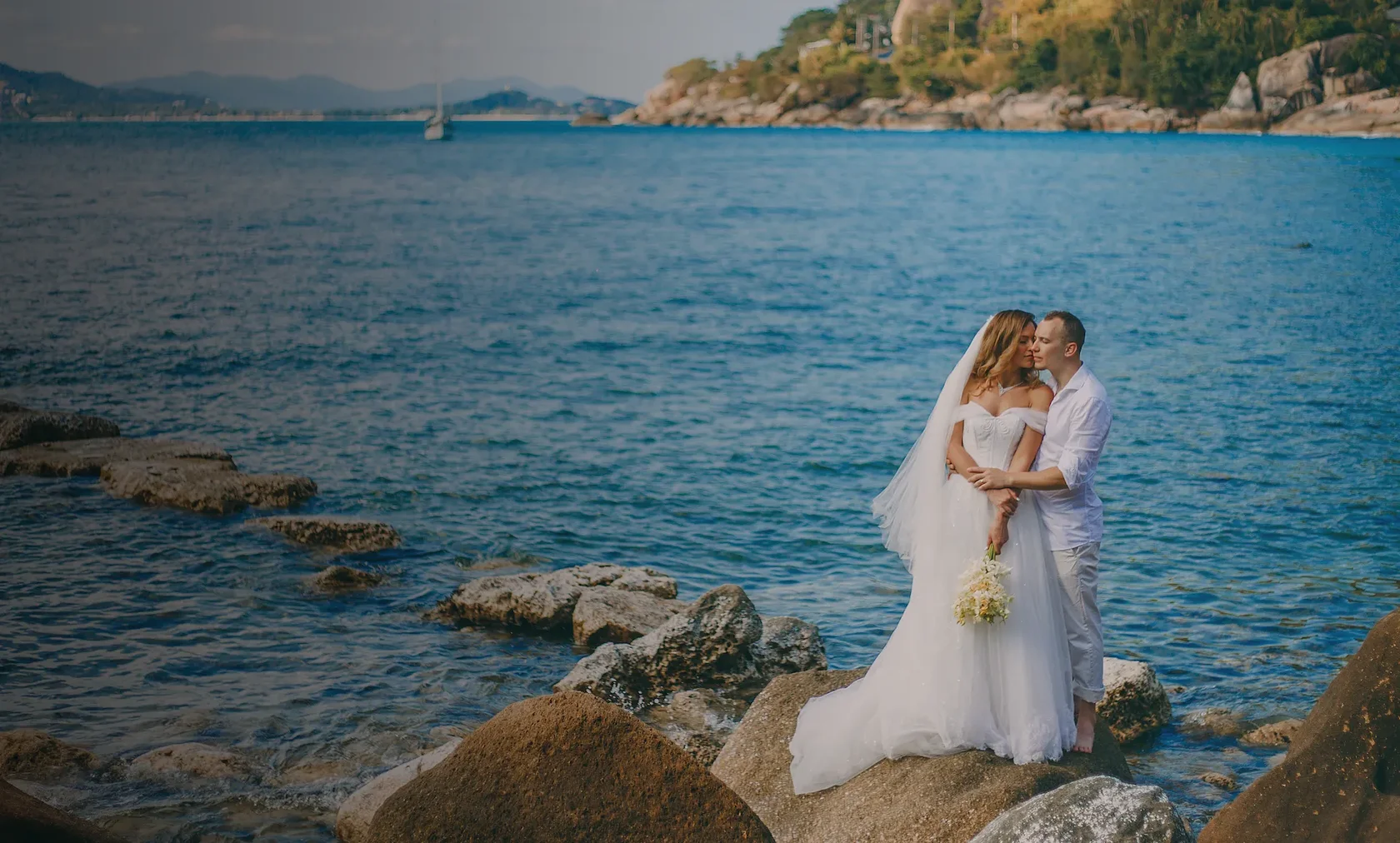 Elegant bride and groom posing on a tropical beach in Koh Samui, natural daylight wedding photography.