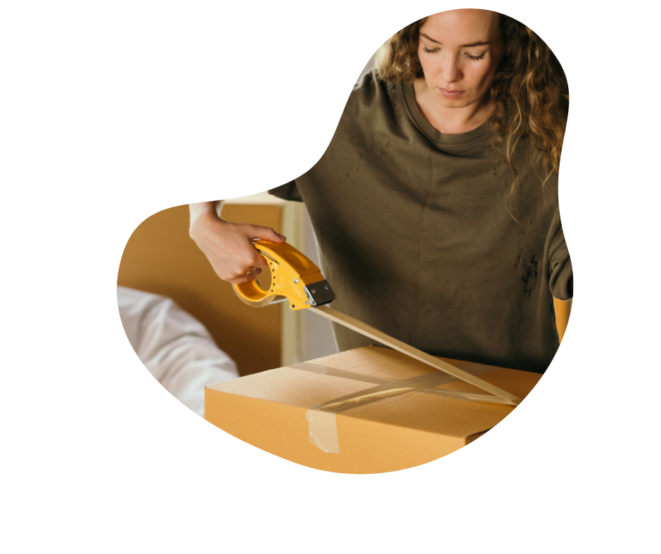 Female cleaner sealing a packing box with packing tape, in a home. 