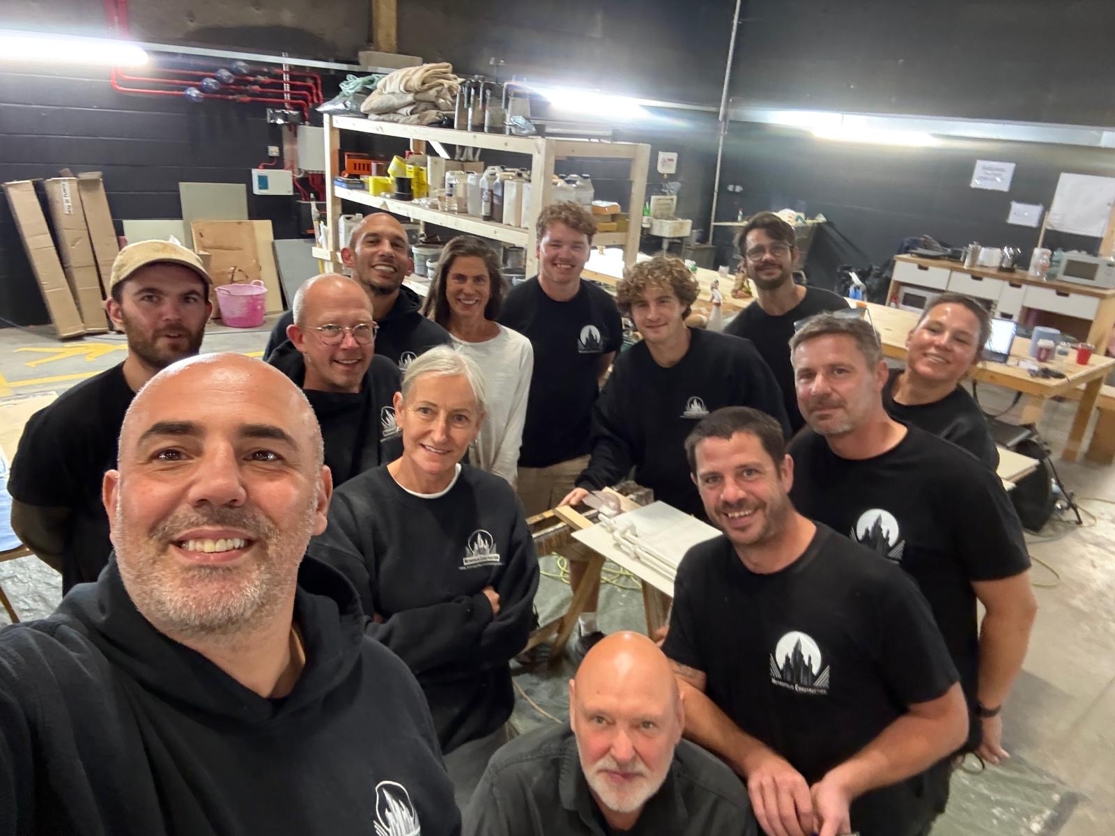 The Metropolis Construction team smiling together in the workshop