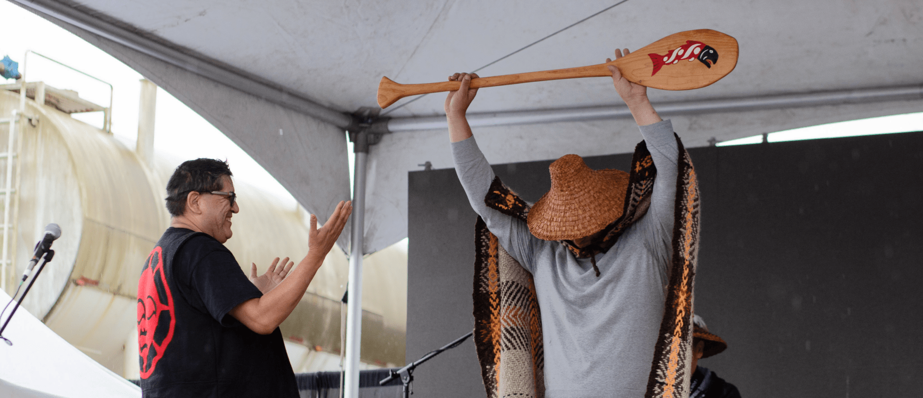 first nation people with canoe paddle 