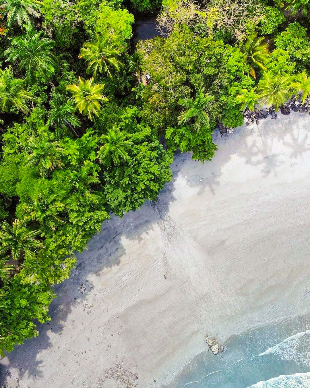 Playita from above — a quiet band of sand between the rainforest and the surf