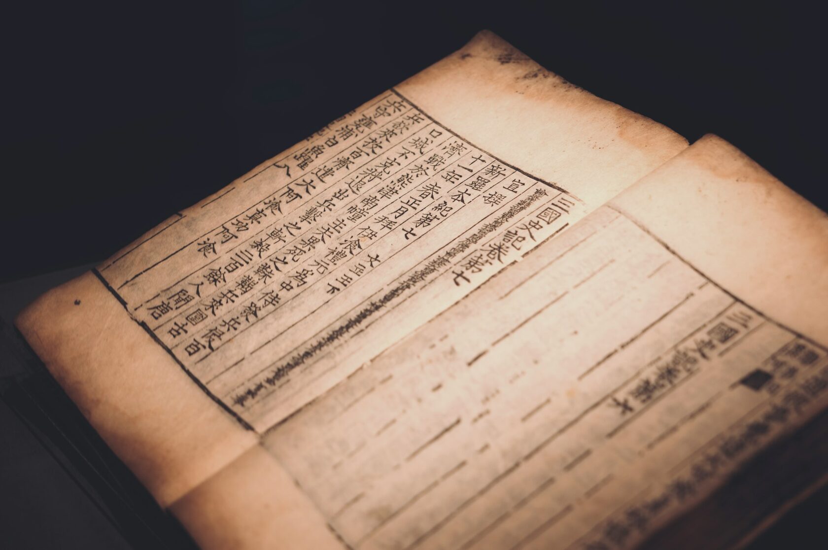 Ancient Nadi Jyotish palm-leaf manuscript resting on a parchment with an astrological zodiac chart