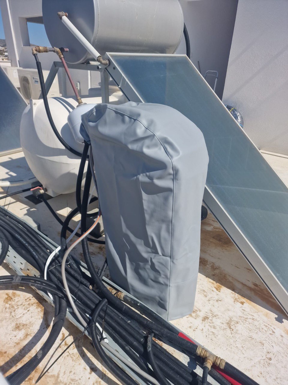 Outdoor water softener wrapped in a custom UV protection cover to shield it from the direct sun.