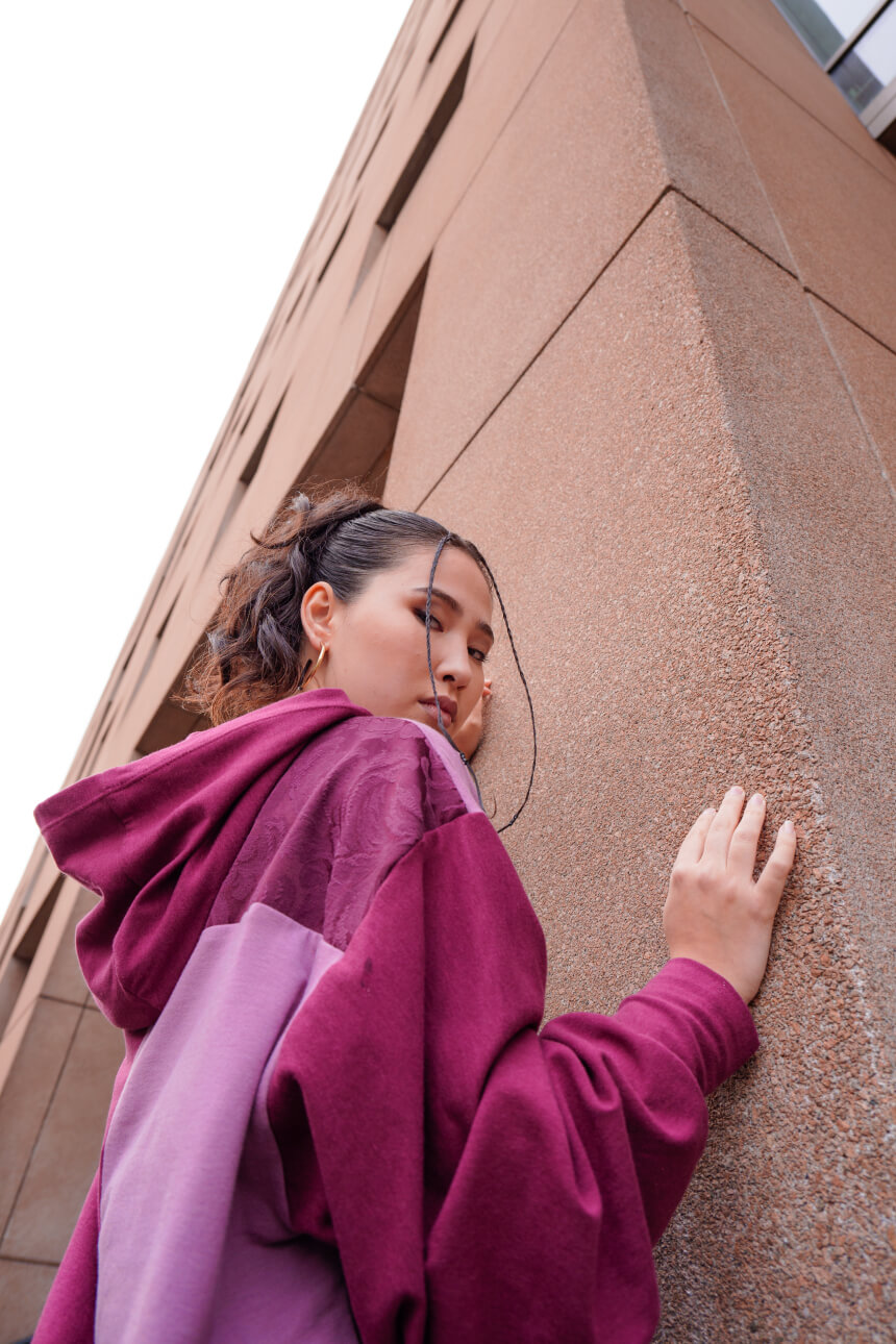 Female model in a burgundy hoodie