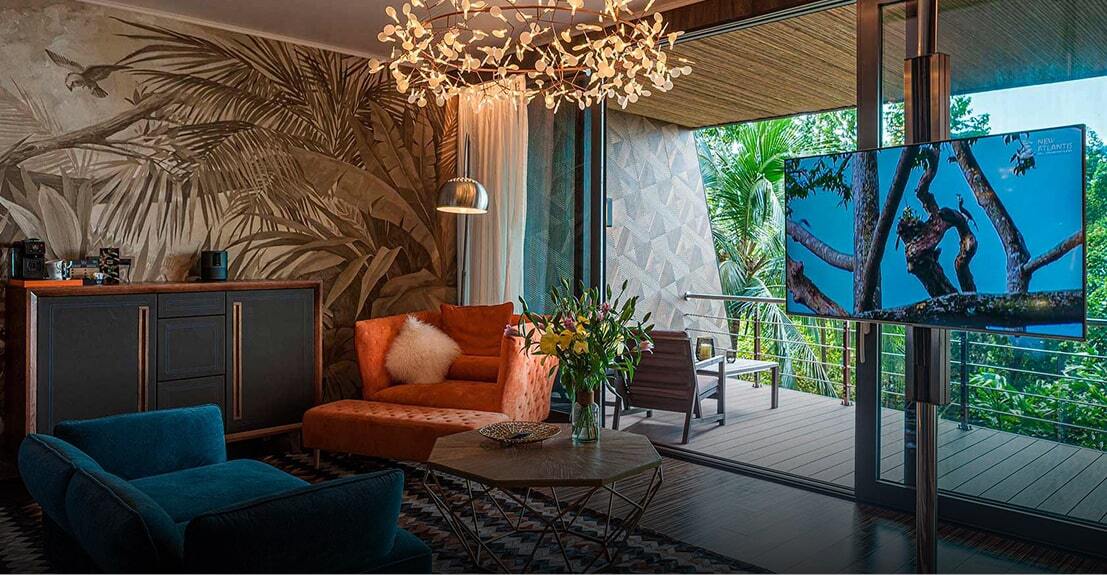 Suite living room with floor-to-ceiling jungle views at Makanda by the Sea