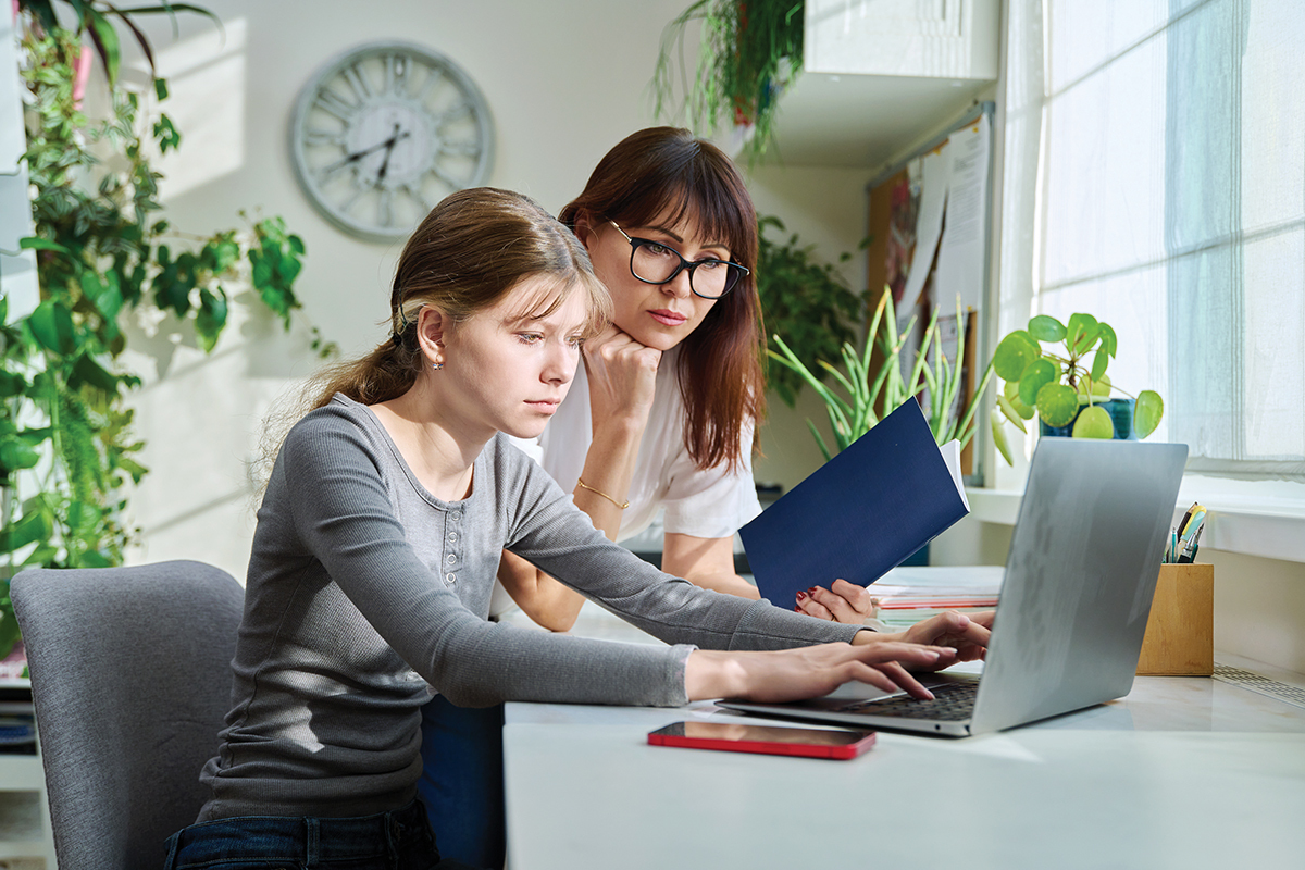 Two designers reviewing UI on a screen