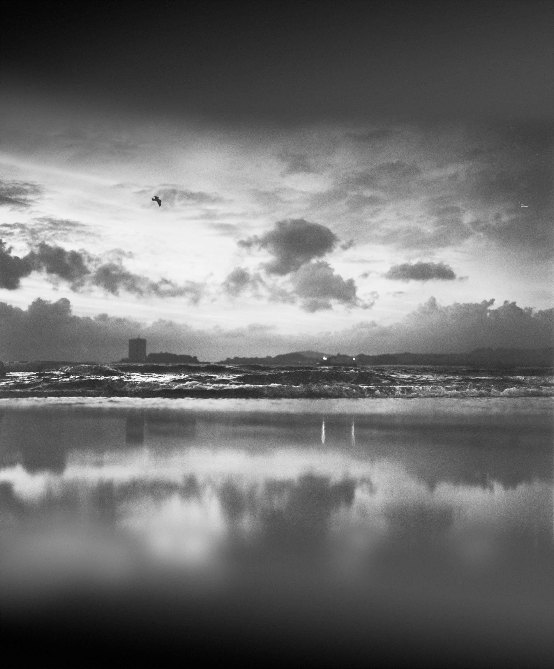 The Samil beach. Spain. Waves, clouds and reflections