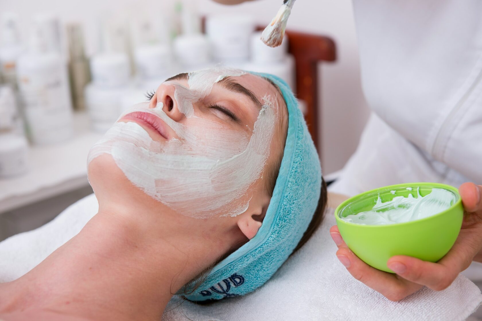 Professional cosmetologist performing facial treatment procedure
