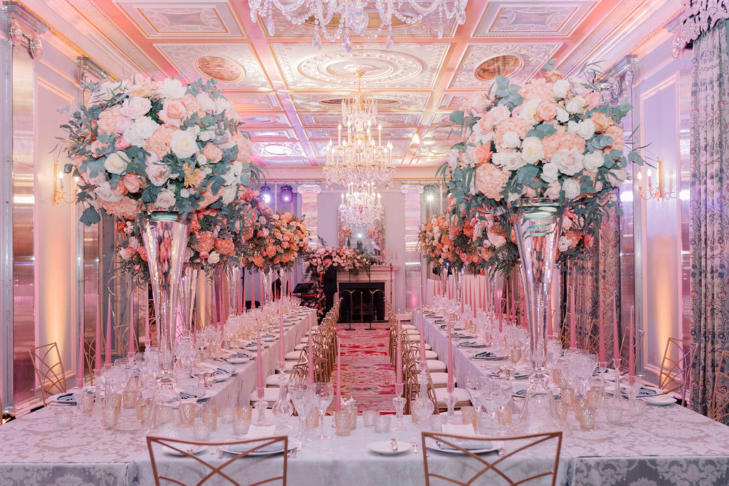 1920s birthday dinner setup with tall flower arrangements and candles at Belgravia Room in Lanesborough Hotel, London