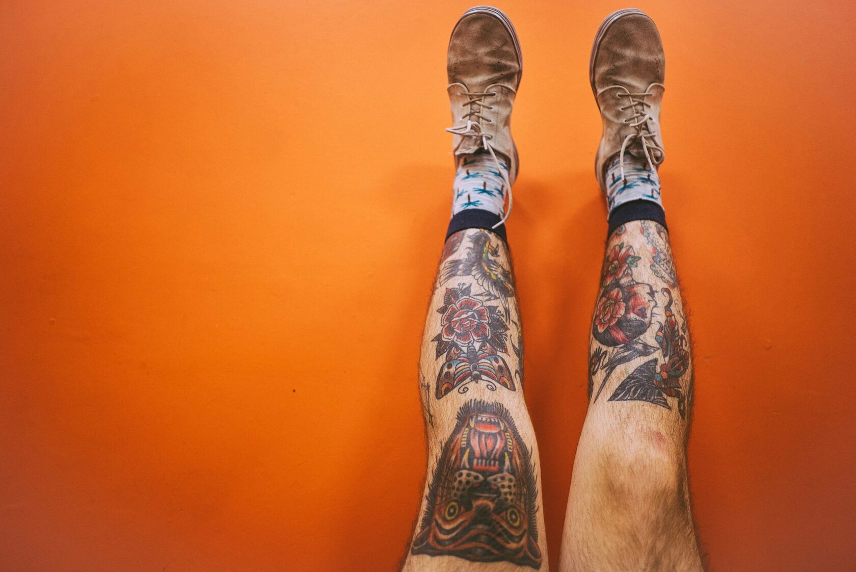 Minimal face tattoo on calf